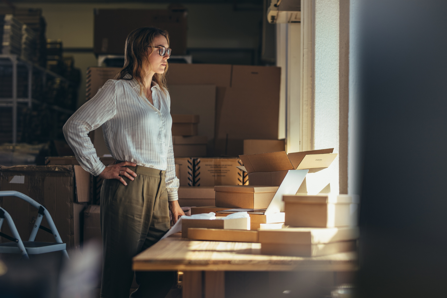 Business owner staring out the window, deep in thought.