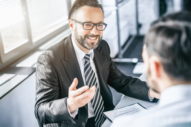Business owner and broker about to shake hands.