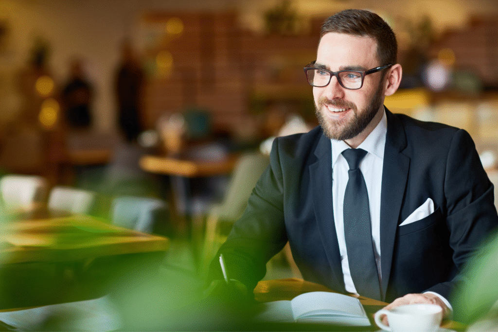 A business owner smiling while looking into the distance.
