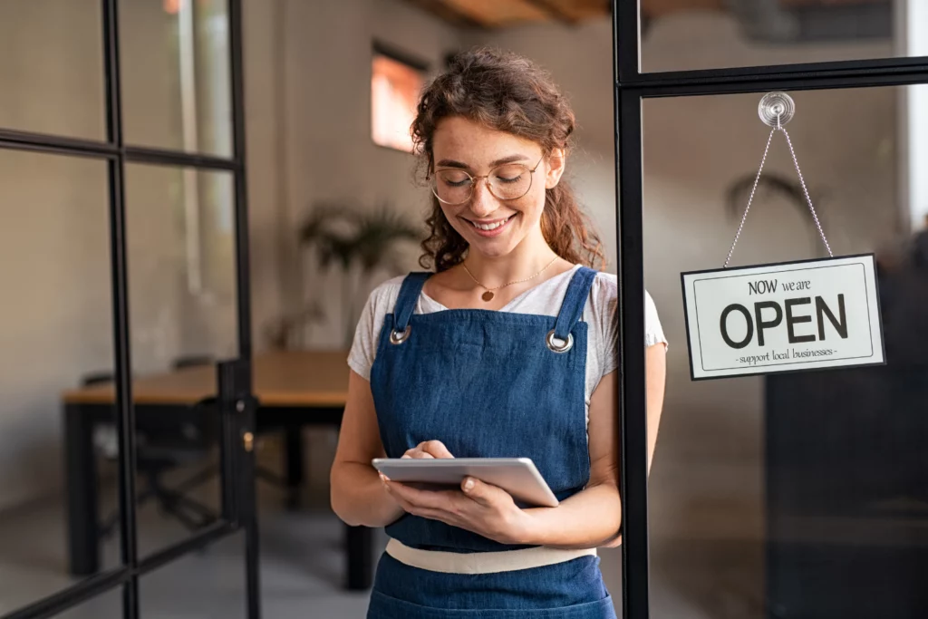 Business owner reading messages on phone.