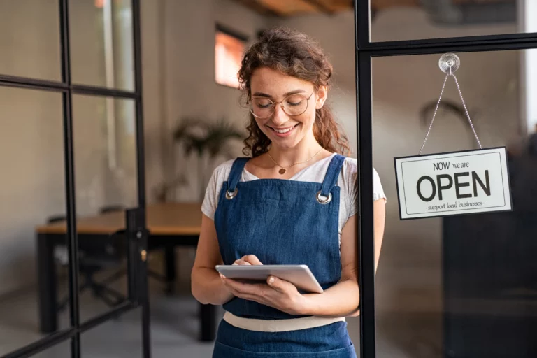 Business owner reading messages on phone.