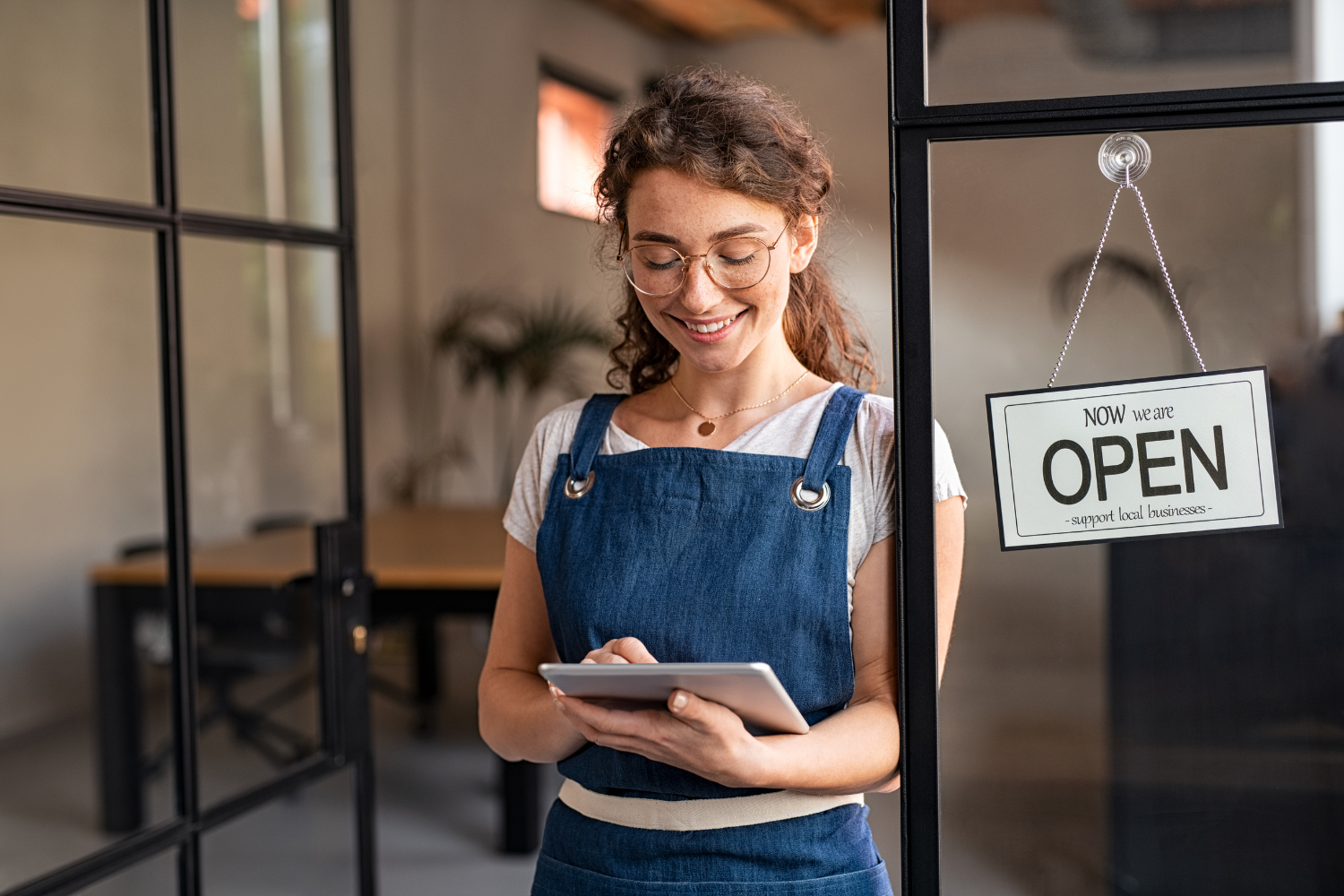 Business owner reading messages on phone.