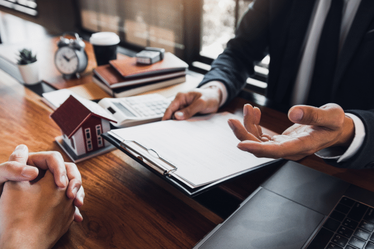 Close-up of business owner signing documents to finalize a sale with broker guidance