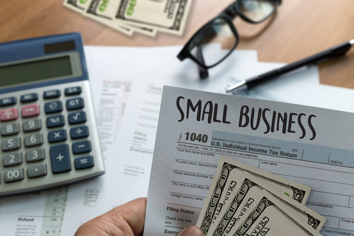Small business tax documents and cash prepared for business sale process