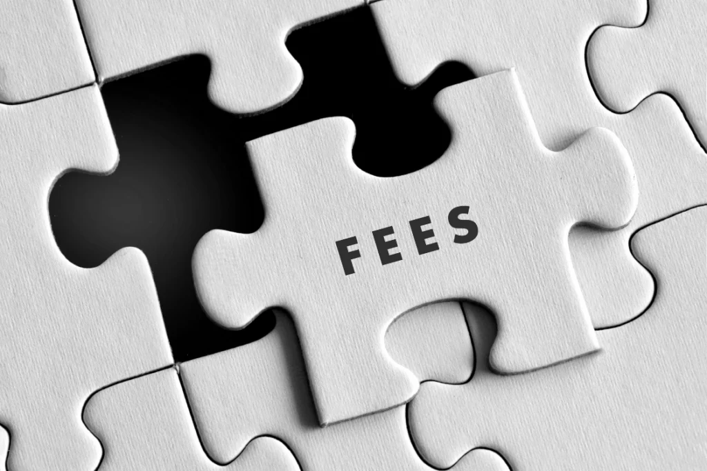 Jigsaw puzzle with the last piece labeled FEES being put in place, symbolizing the necessity of clear broker fees in an engagement letter.