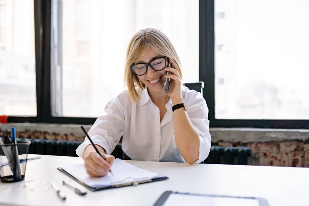 Person taking notes while asking follow-up questions about a broker
