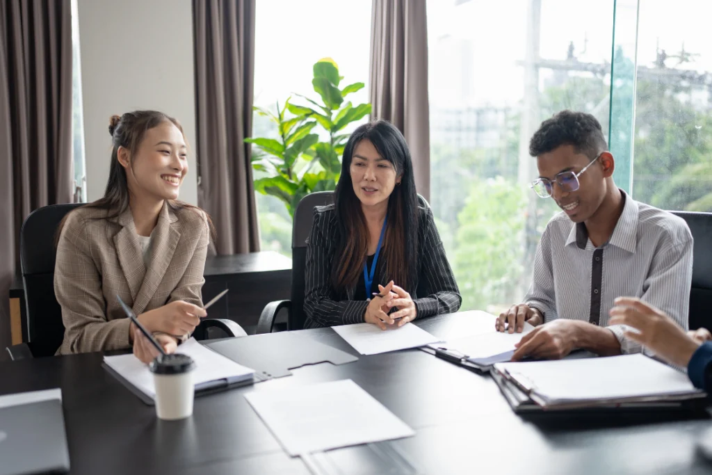 A diverse team of professionals in a meeting room, collaborating on documentation related to business valuation cost and financial reporting.