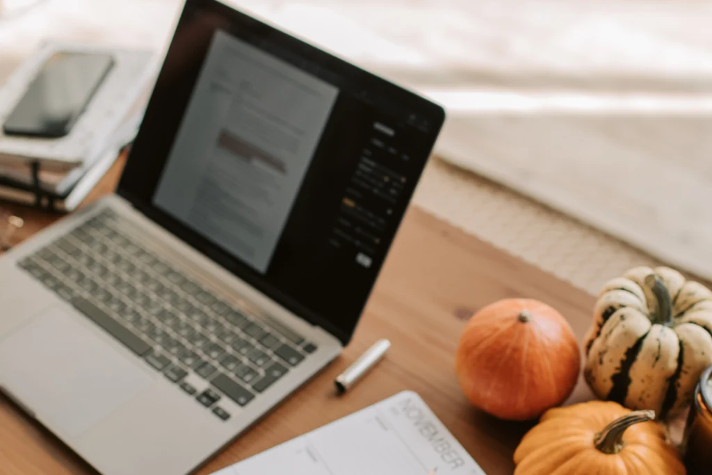 A laptop and calendar suggesting strategic planning for new customers and setting kpis to track for better sales performance.