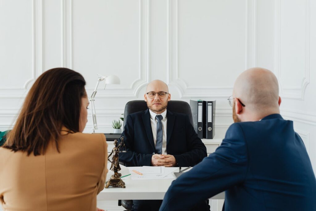 Couple consulting a lawyer in a professional office setting