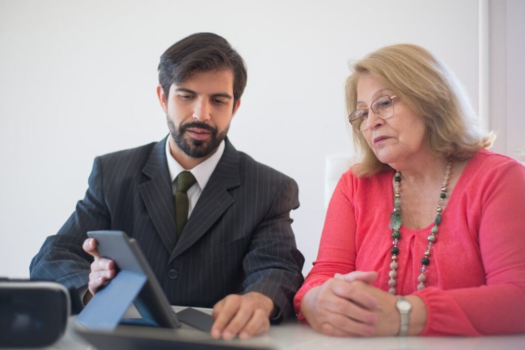 Business professionals reviewing documents on a tablet during a meeting