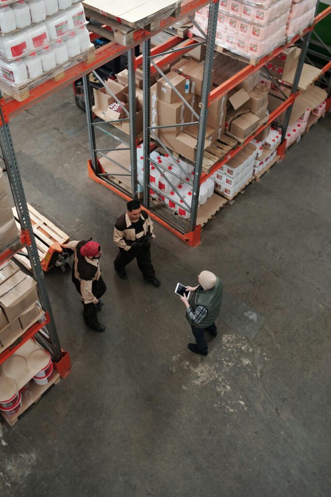 Workers discussing logistics and operations in a warehouse setting