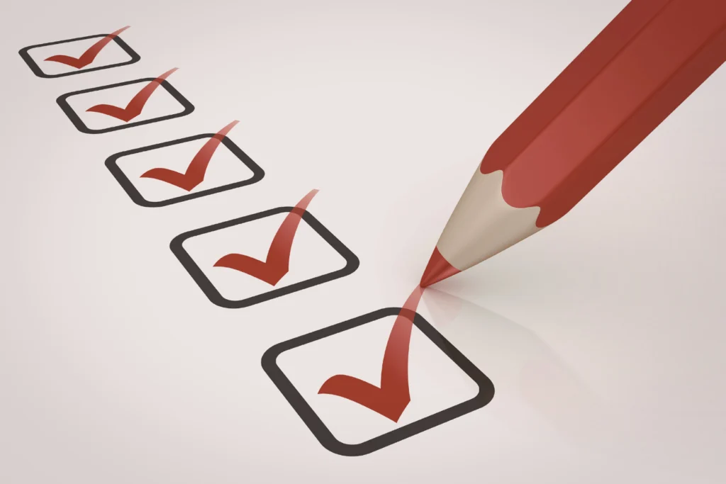 Red pencil checking off five boxes