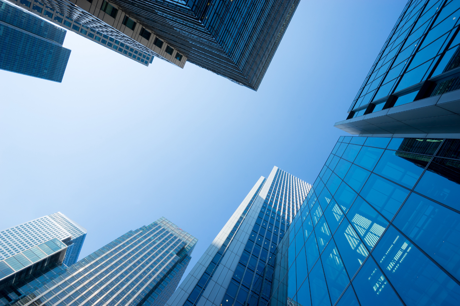 Modern skyscrapers converging toward the sky, symbolizing growth and scale, used to represent a small business KPI dashboard for tracking performance.