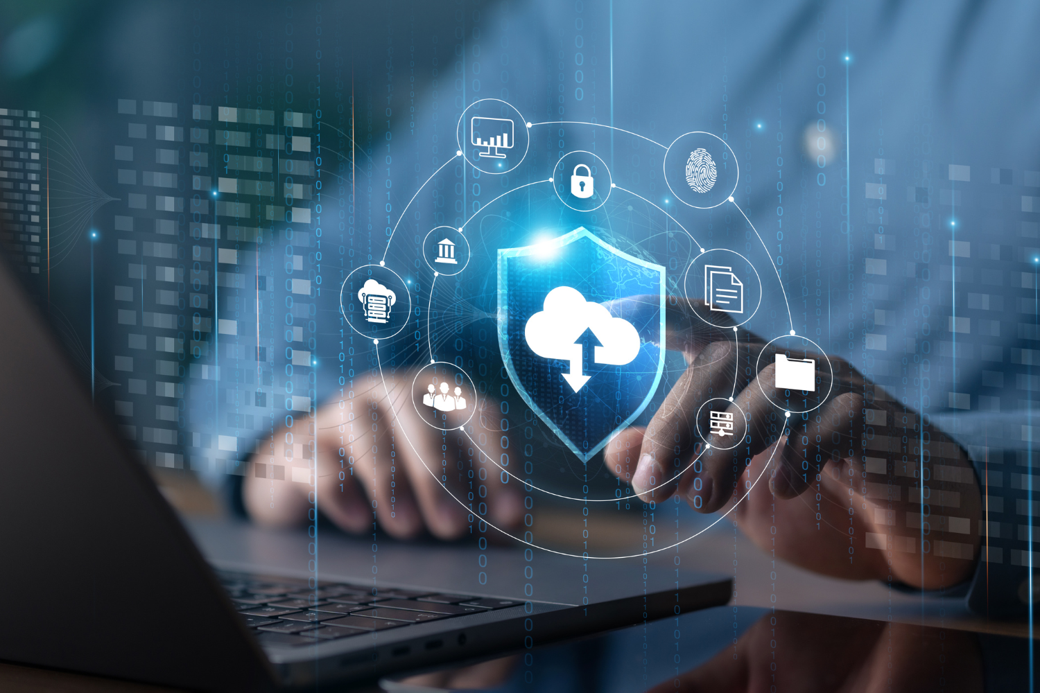 Laptop with cloud security and data protection icons, representing a technology system audit before selling a business.