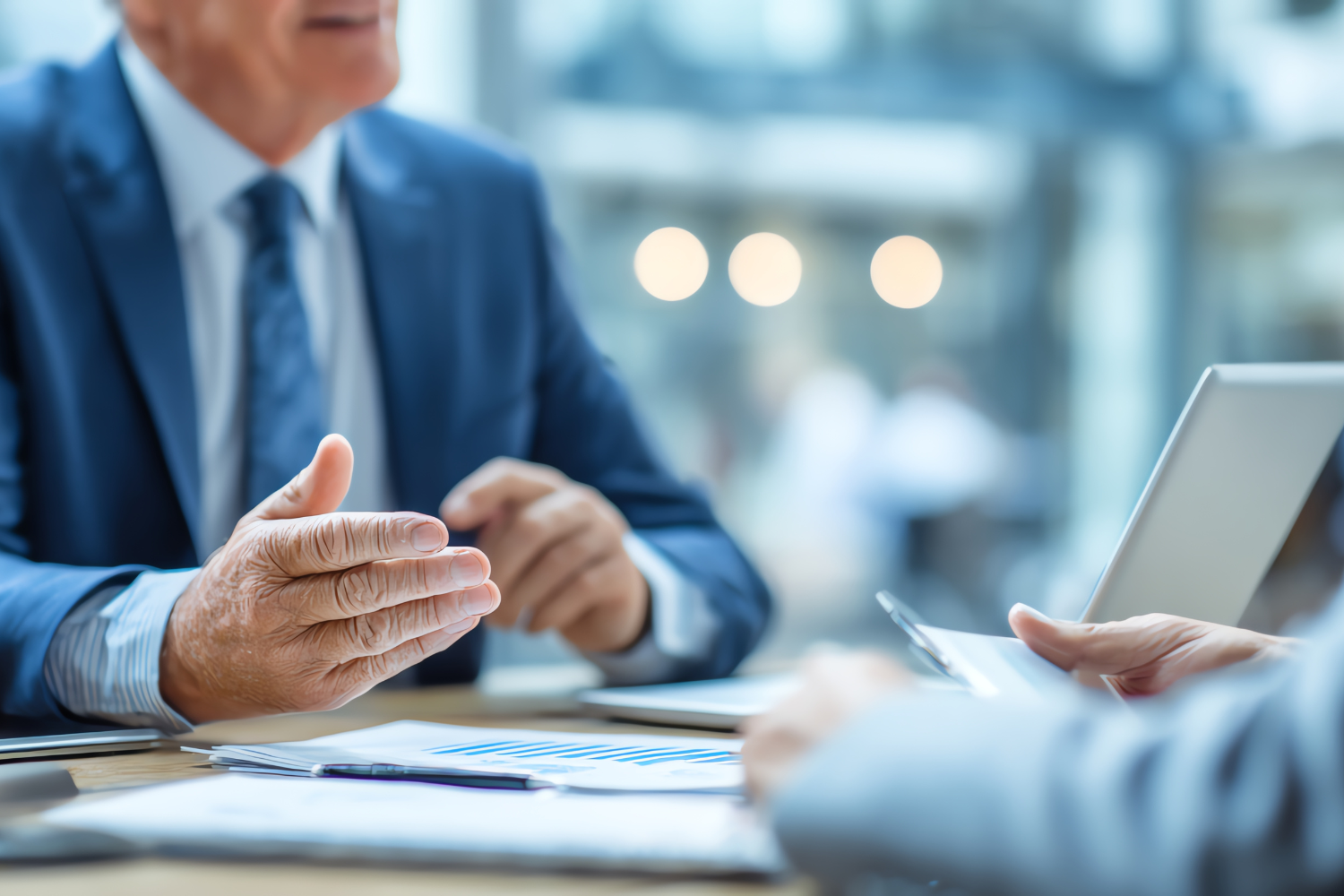 Business professionals reviewing reports in a meeting, representing owner dependency and key person risk before selling a business.