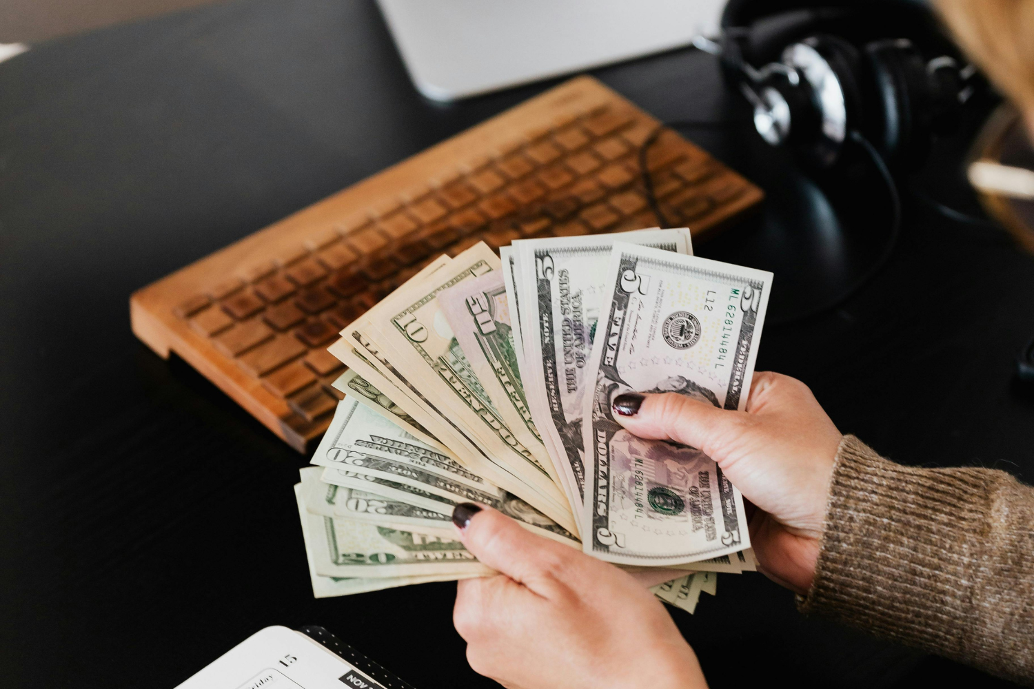 A business owner documenting and counting their earnings.